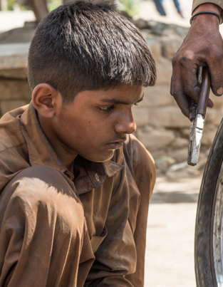 Poor child looking at a bicycle