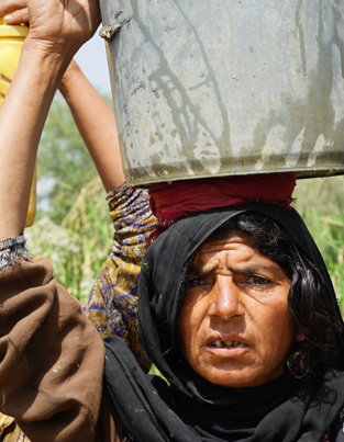 Old women holding bucket on her head